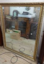 A modern ornate gilt framed bevelled oblong wall mirror by Morris Mirrors - 1m X 1.3m