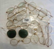 A bag containing a large quantity of gold plate rimmed spectacles of various form