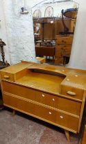 A 98cm retro oak effect dressing table with shaped swing mirror and flanking trinket drawers, over a
