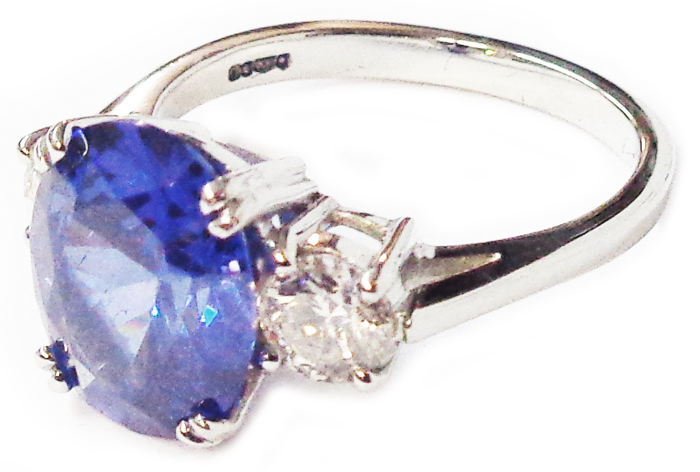 A hallmarked 950 platinum ring, set with central 5.38ct. oval tanzanite flanked by two diamonds -