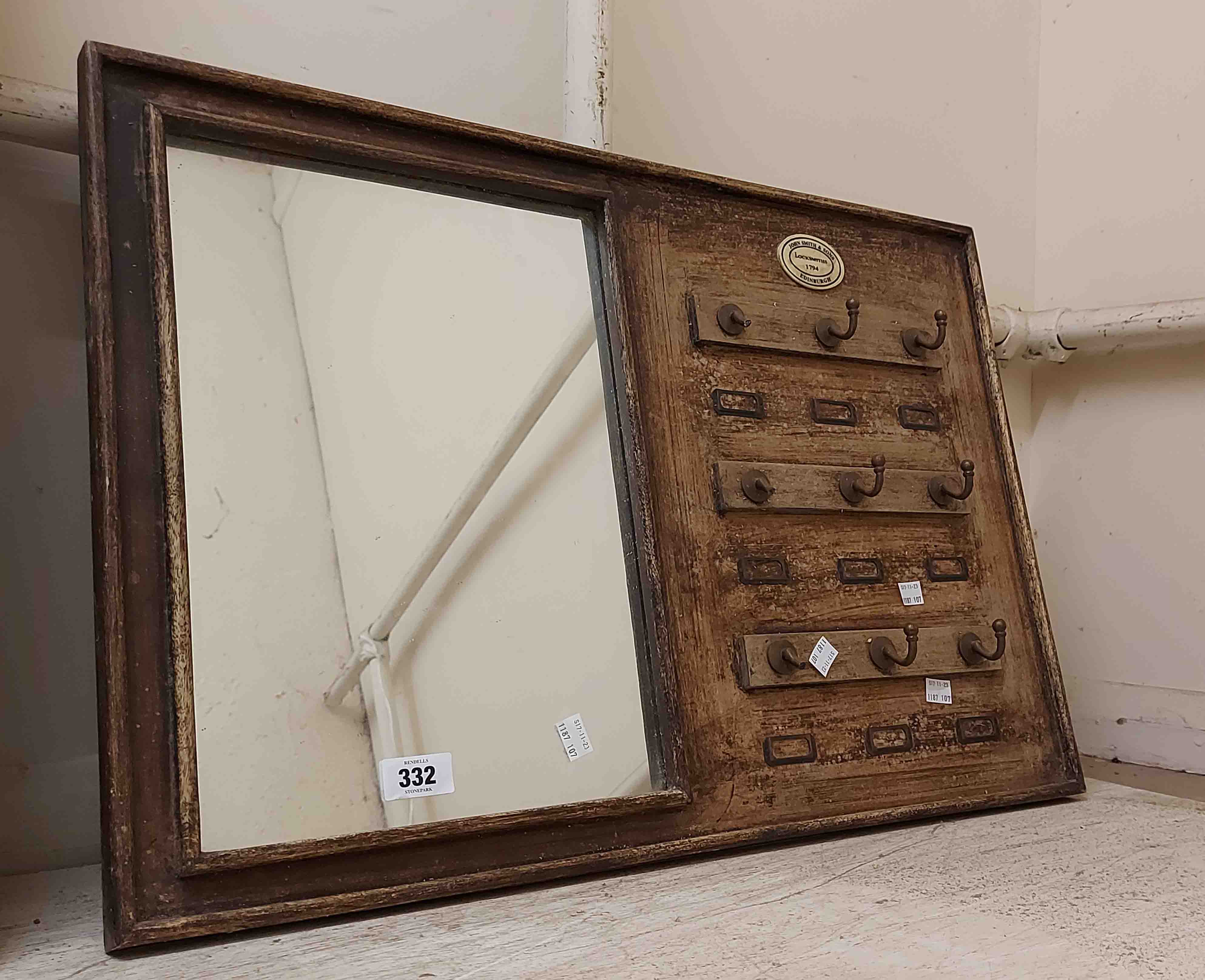 A vintage locksmith's key hanger wall mirror - marked for 'John Smith & Sons, Edinburgh,