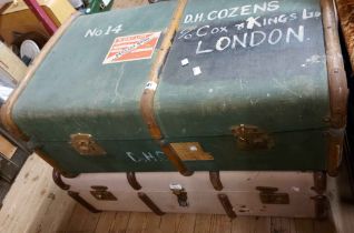 Two vintage cane bound travelling trunks with canvas weather coating