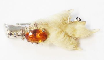 An Edinburgh silver mounted ptarmigan foot brooch, set with amber glass stone