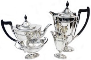 A silver four piece tea and coffee set of neo classical design with ebony handles and knops to pots,