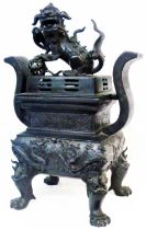 A large antique Chinese incense burner of square form set on lion mask and paw legs, the body