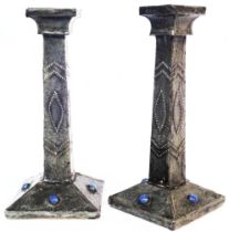 A pair of Arts and Crafts Movement pewter clad candlesticks with applied cabochons