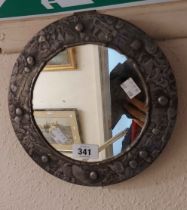 A 24cm diameter vintage wall mirror with decorative silvered copper border