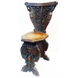A 19th Century ornate carved oak Renaissance Revival carved oak chair with profuse decoration and