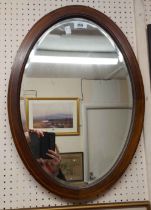 An Edwardian mahogany and strung bevelled oval wall mirror - sold with a wall mirror from a swing