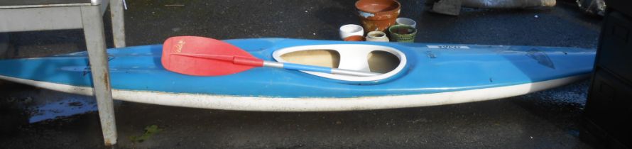 A 3.9m 'Mad Sports' blue fibreglass kayak with paddle