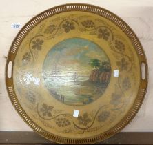 A 19th Century Toleware circular tray with pierced gallery, a central painted panel depicting