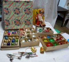 An old Tom Smith cracker box containing a quantity of vintage Christmas decorations including
