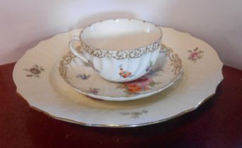 A Dresden porcelain tea cup and saucer of fluted form with hand painted floral decoration - sold