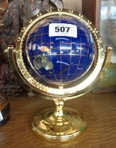 A small modern inlayed hardwood world globe with brass stand
