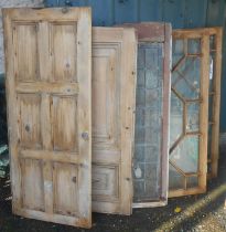 A pair of old pine astragal glazed doors - sold with a leaded similar and two panelled cupboard