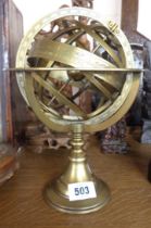 A modern brass astrological style globe