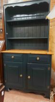 A 94cm modern two part pine dresser with two shelf open plate rack, over a base with two frieze