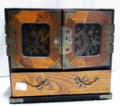 An old Japanese jewellery box with panelled cover doors enclosing six lacquered drawers with large
