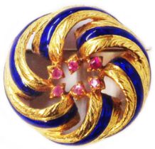 A yellow metal open swirl brooch with blue enamel line detail and tiny pink rubies to centre