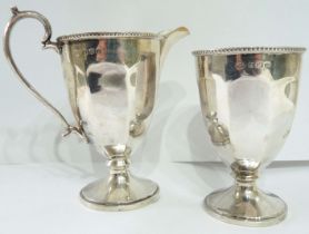 A matching Birmingham silver cream jug and goblet shaped vessel of faceted pedestal design