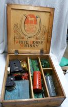 A wooden White Horse Whisky advertising box containing a quantity of vintage Meccano including