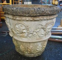 A large concrete planter of tapered form with moulded classical decoration - cracks