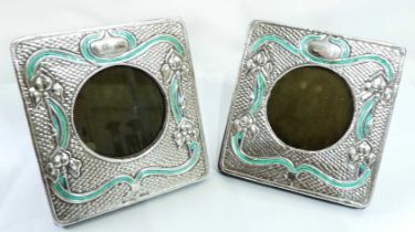 A pair of small marked 'sterling'/GL 915 Art Nouveau design photograph frames with green enamel line