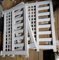 Two boxed modern white plastic fence panels