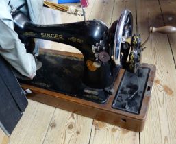 A vintage Singer sewing machine, with soft cover