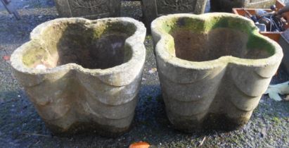 A pair of concrete planters of quatrefoil design