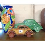 A large ceramic car model with green glaze finish, and a smaller wooden similar - sold with an