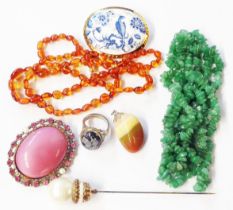 A bag containing hardstone and other costume jewellery, also a honey amber bead necklace
