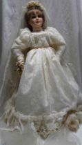 A large modern Alberon porcelain headed doll wearing a wedding dress