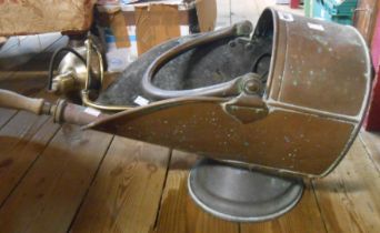 An antique coal scuttle of helmet form - sold with a garden spray pump and brass table lamp