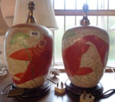 A pair of Chinese style ceramic table lamps with hand painted goldfish decoration, set on turned