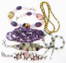 Two ornate bracelets comprising one set with various shaped amethysts and pale green hardstones, the