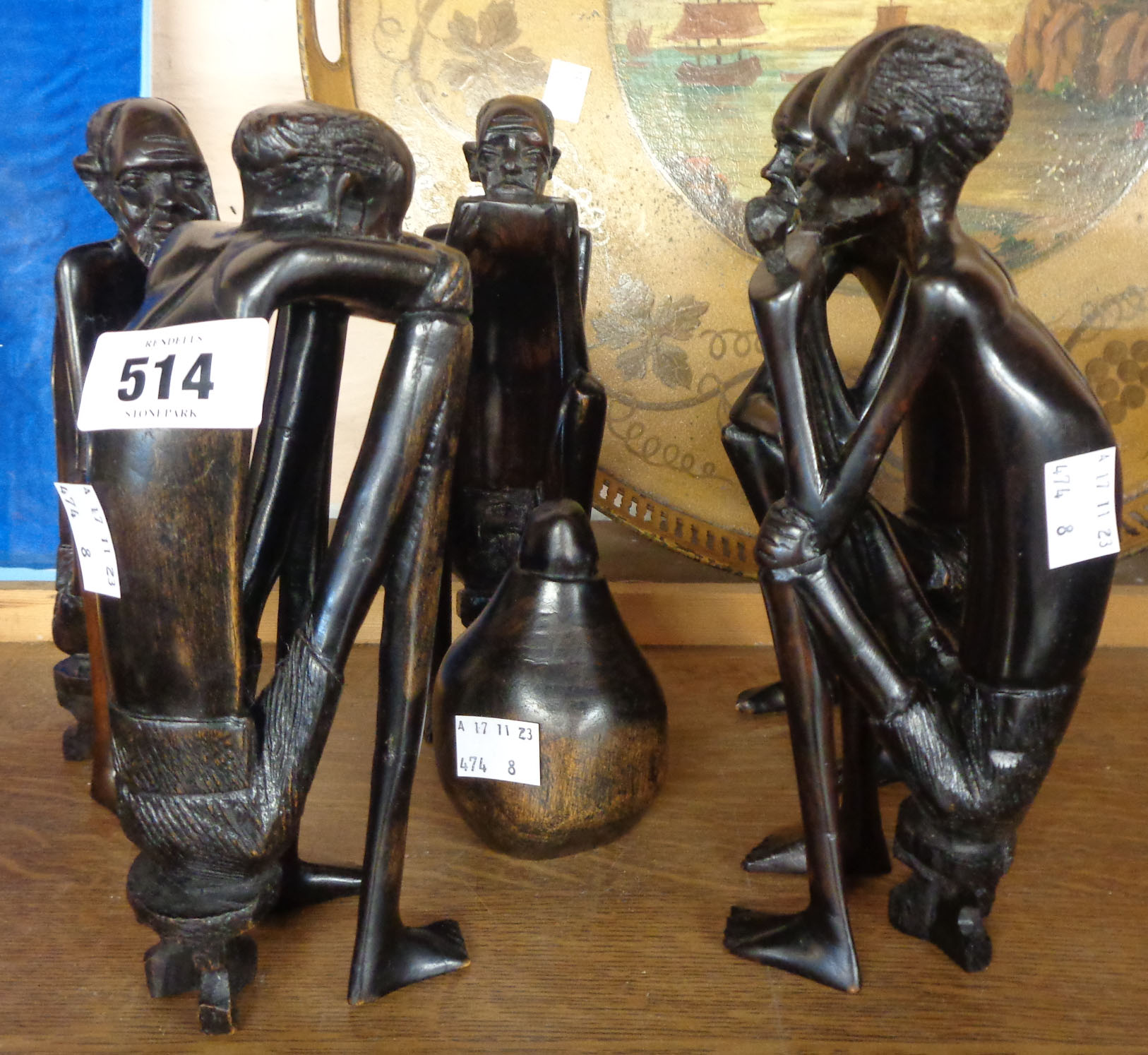 A group of five African carved ebony seated figures with central gourd style pot - some arm cracks - Image 2 of 2