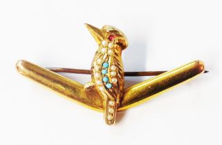 A marked '9' Australian yellow metal brooch in the form of a gem set kookaburra perching on a