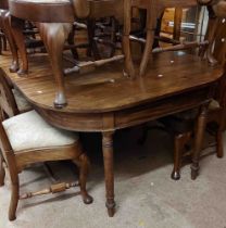 An antique mahogany extending dining table comprising two D-ends with gated action and two centre