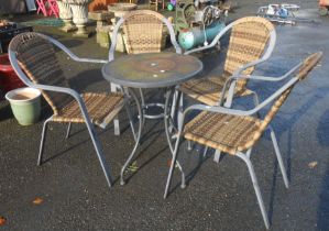 A modern circular metal patio table - sold with four garden elbow chairs