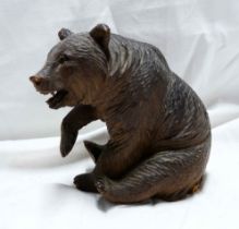 An early 20th Century Black Forest carved wood bear figurine with inset bead eyes