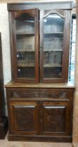 A 1.05m early 20th Century stained mixed wood two part secretaire/bookcase with shelves enclosed