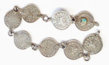 A bracelet made from eight Arabic silver coins, one with turquoise cabochon
