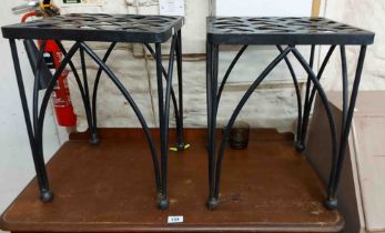 A set of four black painted wrought iron kitchen stools of lattice design