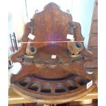 An antique oak corner pipe stand - sold with two pipes