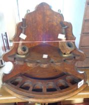 An antique oak corner pipe stand - sold with two pipes