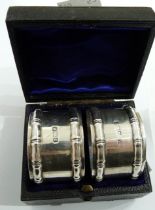 A cased pair of blank Sheffield silver napkin rings with cast bamboo style borders - 1892