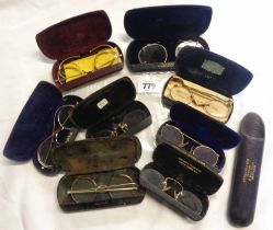 A bag containing a eight cased gold plated rimmed spectacles of various form - sold with an empty