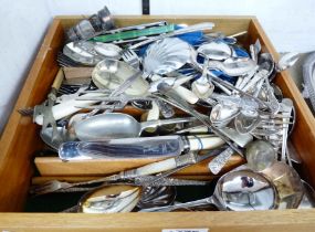 A drawer containing a quantity of assorted silver plated and other cutlery, also collectable items