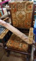 An early 20th Century mahogany show frame American rocking chair with studded tapestry upholstery